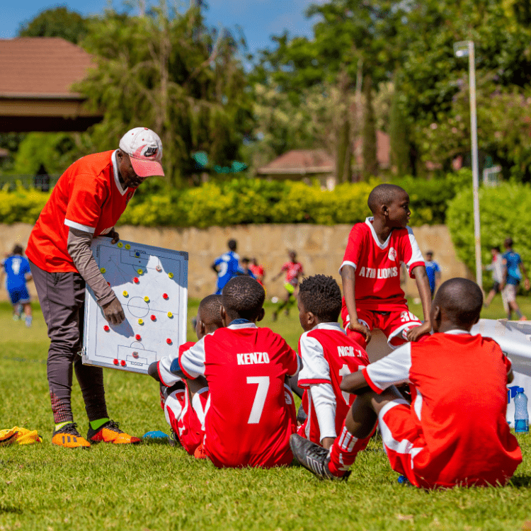 a football coach training a group of little boys