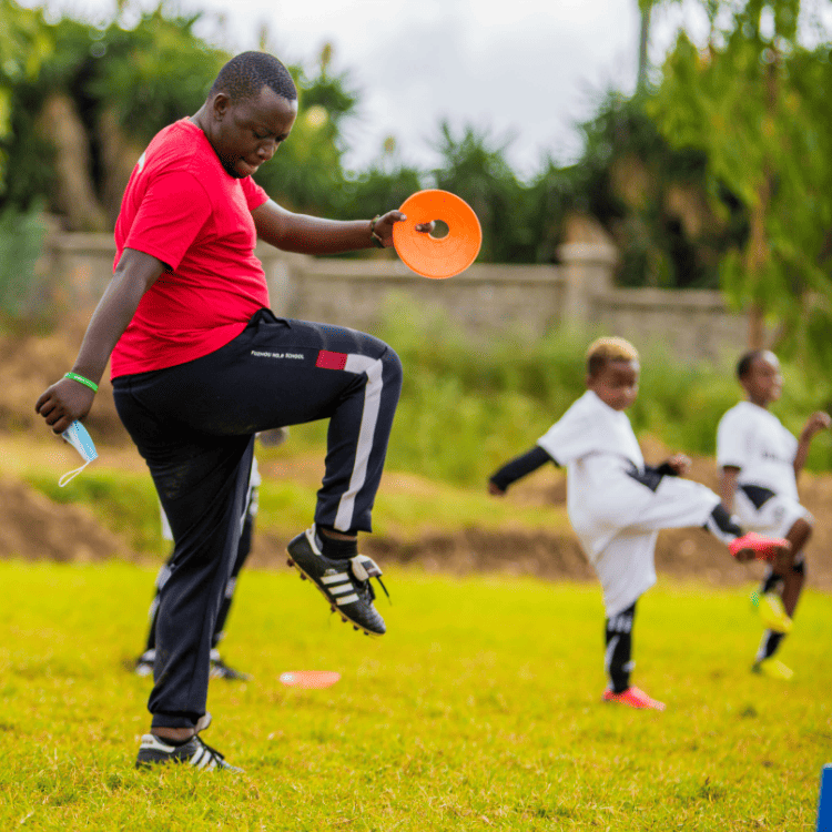 football coach training boys on how to play football