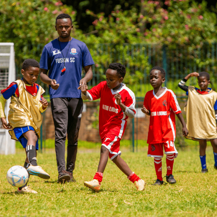 football coach training pre-teen boys how to play football
