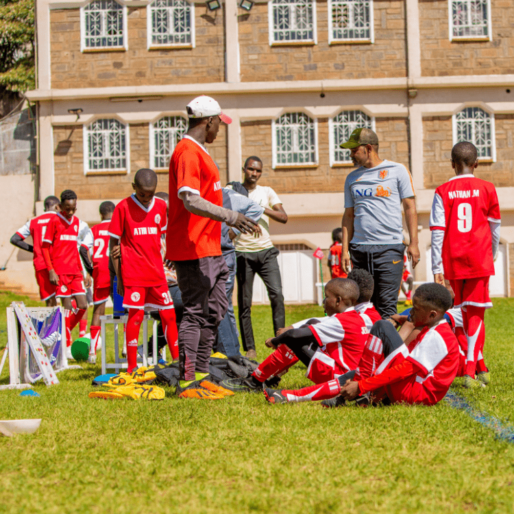 football coaches advising a team of young boys